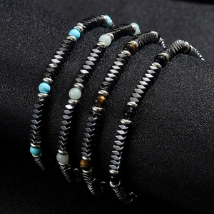 Detailed view of stacked hematite arrow bracelets with natural turquoise and tiger eye stone