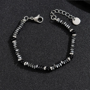 Detailed close-up of faceted hematite and black round beads on a beaded bracelet
