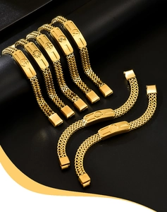 Macro detail of gold stainless steel Cuban link bracelet with engraved rectangular plaque