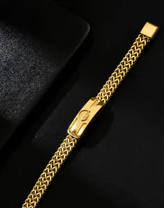 Close-up of gold stainless steel Cuban link bracelet with engraved metal plate