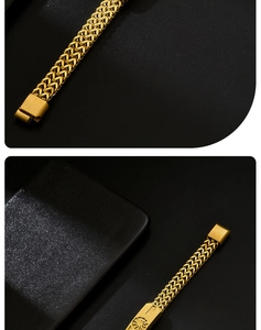 Detail view of golden Franco wheat chain bracelet with engraved fold-over clasp design