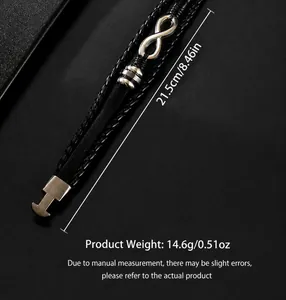 Detail of black woven leather bracelet featuring silver infinity charm and metal clasp