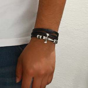 Men's multilayer black leather bracelet featuring silver skull cross charm on white background