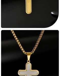 Close-up of golden box chain necklace with a textured cross pendant on black background