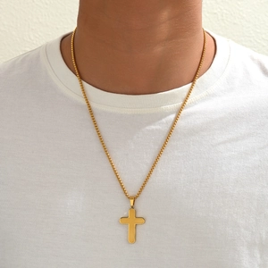 Minimalist gold stainless steel cross necklace with box chain worn by a model