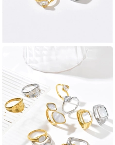 Detailed display of irregular mother-of-pearl rings with gold and silver finishes