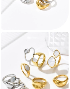 Macro shot of minimalist gold and silver shell inlay rings with clear zircon accents
