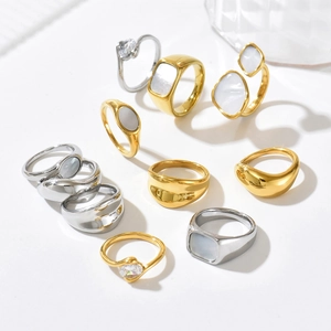 Collection of geometric stainless steel rings with shell inlays and crystal accents