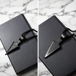 Macro detail of black stainless steel spearhead pendant with V-groove texture for men