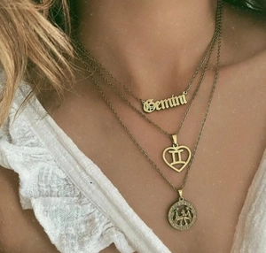 Three-layer gold-plated Gemini zodiac necklace set with heart and coin pendants on model