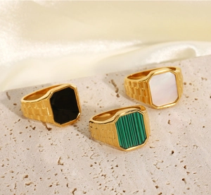 Macro view of rectangular 18K gold plated stainless steel rings with malachite and onyx