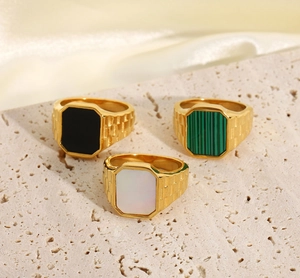 Detailed macro view of 18K gold plated stainless steel rings with colorful stone inlays