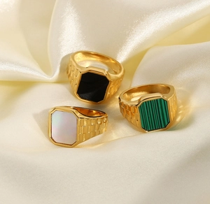 Detailed view of three vintage 18K gold-plated stainless steel rings with colorful stones
