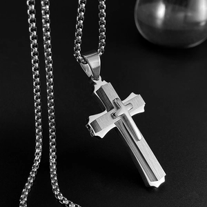 Detail of silver double-layered cross pendant with brushed finish on bead chain