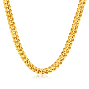 Mens thick Cuban link chain necklace in gold finish with reflective metallic luster
