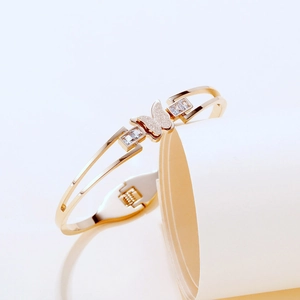 Detail of gold butterfly bracelet featuring frosted glitter wings and zircon accents