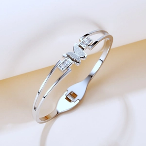 Detail of silver titanium butterfly bangle with frosted motif and cubic zirconia accents
