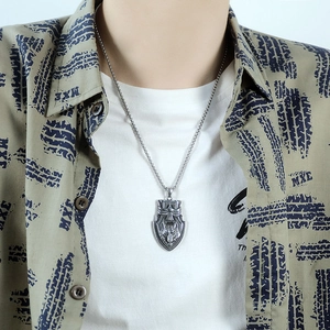Detailed view of men's vintage shield wolf head pendant necklace on a silver chain