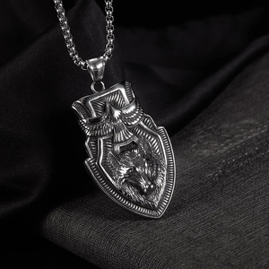 Detailed close-up of retro shield pendant with eagle and wolf head relief on box chain