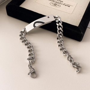 Dettaglio del bracciale a catena cubana in acciaio inox con pietra nera e targa incisa