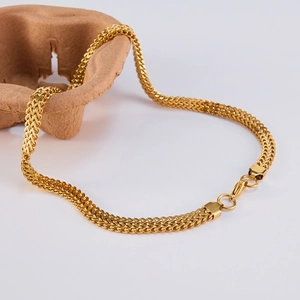 Detail of gold double-row link chain necklace featuring a durable lobster clasp closure