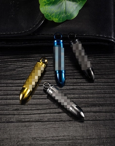 Macro detail of bullet-shaped stainless steel pendants in gold, blue, black, and silver finish