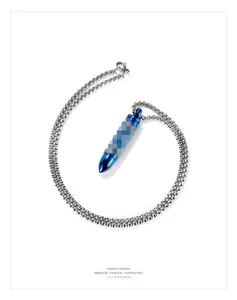 Macro view of blue bullet pendant with silver stainless steel box chain for men
