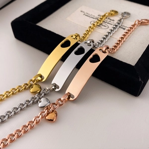 Detailed close-up of three-color polished stainless steel bracelets with hollow heart plates