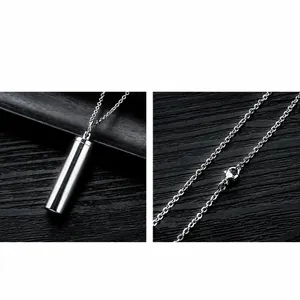 Detail of polished stainless steel cylinder cremation pendant with cross chain and clasp