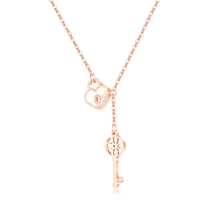 Rose gold Y-shaped necklace featuring a mother of pearl heart lock and hollow key charm