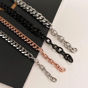 Close-up of Cuban link chains in silver, black, rose gold, and steel finishes