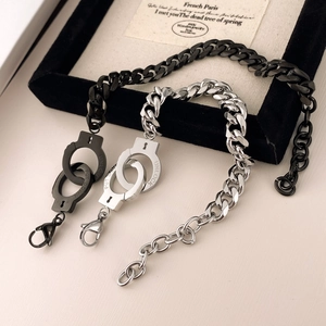 Black and silver stainless steel handcuff bracelets featuring custom UNLOCK engraving