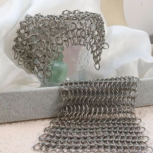 304 stainless steel cast iron cleaner chainmail scrubber on glass and grey stand