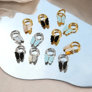 Colorful butterfly charm hoop earrings in gold and silver finish with resin pendants