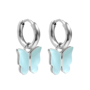 Detail of silver hoop earrings with translucent light blue butterfly pendants on white