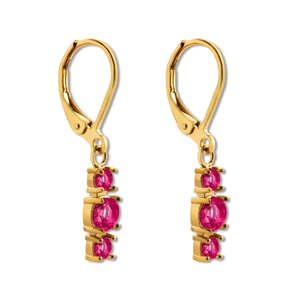 Detail view of leverback gold earrings with three vertically set pink gemstones