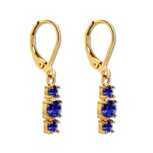 Close-up of golden leverback earrings with three graduated blue zircon stones in prongs