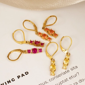 Golden lever-back earrings set with vertical trio of orange, pink and yellow round zircons
