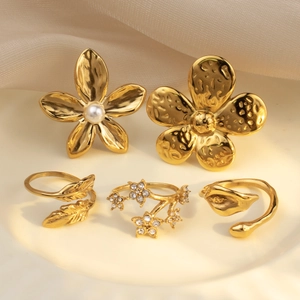 Five-piece gold jewelry set featuring floral earrings and nature-inspired open rings