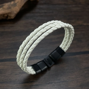 Detail of white multi-layer braided leather bracelet with black matte magnetic clasp