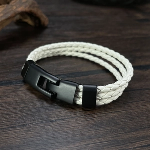 Detail view of white multilayer braided leather bracelet with black matte metal clasp