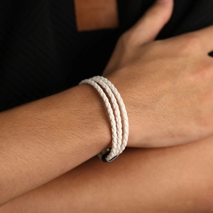 Three-strand braided white leather bracelet for men featuring a black magnetic clasp