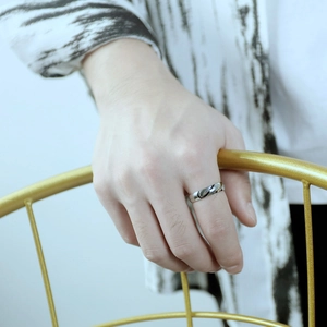 Polished silver heart puzzle couple ring in stainless steel worn by a model