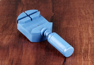 Sky blue watch band link remover tool for adjusting metal straps on wooden surface