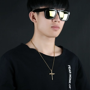 Punk style men's gold stainless steel cross pendant necklace on black background