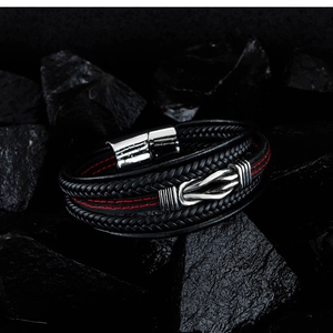 Detailed close-up of multilayer leather bracelet with silver knot and magnetic clasp