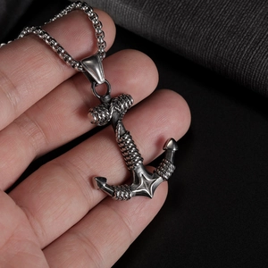 Close-up of vintage stainless steel anchor pendant with intricate rope detailing for men
