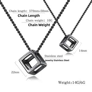 Detail view of large and small hollow cube pendants on stainless steel rope chains