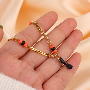 Bracelet en acier inoxydable plaqué or 18k avec perles orange-noir et poing