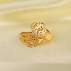 Gold plated stainless steel signet rings with lucky four leaf clover on silk fabric